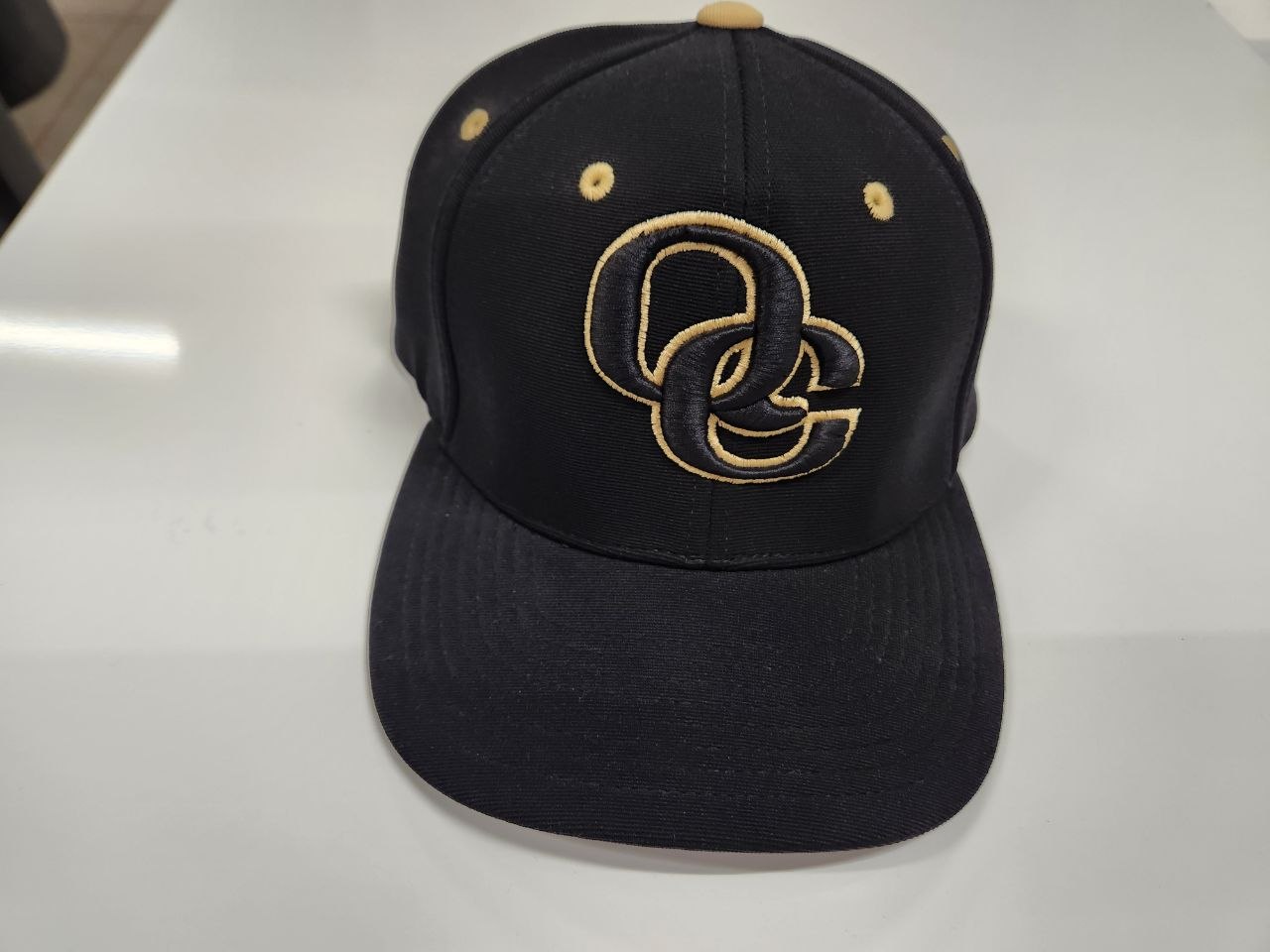 Black snapback hat with gold 3D puff embroidered OC logo