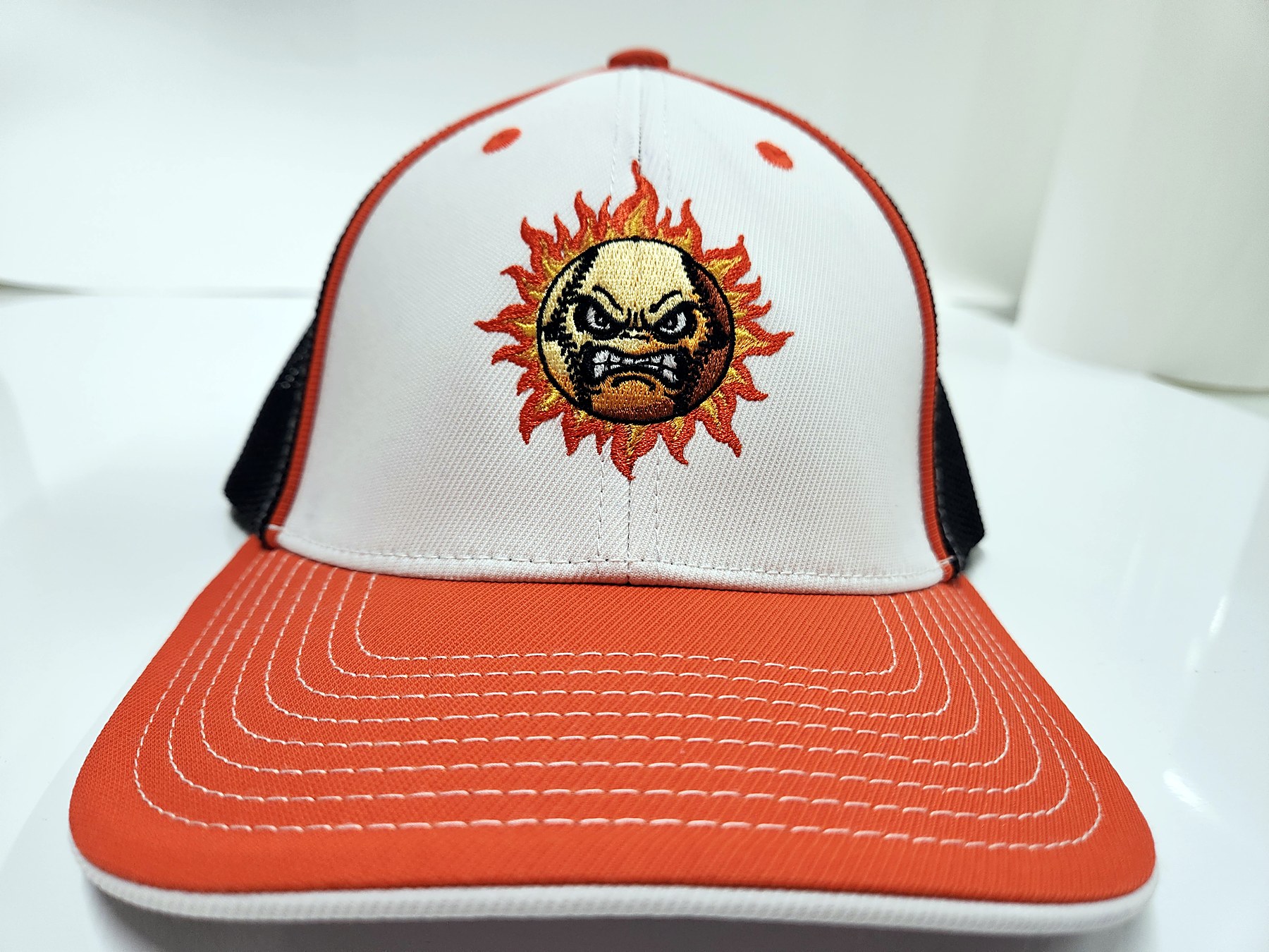 Custom embroidered angry-sun baseball mascot trucker hat by Out There Promos